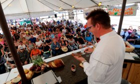 an area cook provides a demonstration on Taste of Colorado festival in Denver, CO
