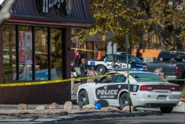 photo - The rear screen of a Colorado Springs Police automobile is shattered by weapon fire at the Wendy's restaurant on Wahsatch Avenue in Colorado Springs as authorities investigate the one for the moments from a shooting rampage that left three sufferers dead Saturday morning, Oct. 31, 2015, in Colorado Springs. The shooting started on Prospect Street near Platte Avenue and ended at Wahsatch and Platte ways where police exchanged gun fire, killing the suspected shooter. (The Gazette, Christian Murdock)